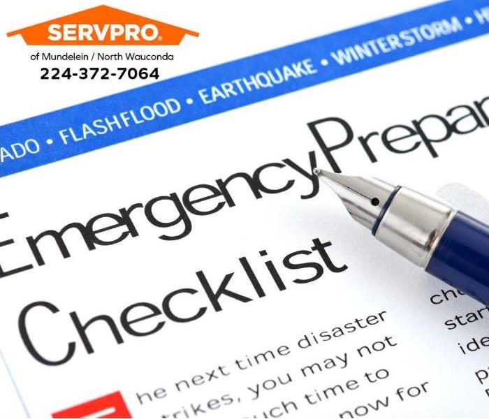 A person checks off supplies on an emergency supply checklist. 