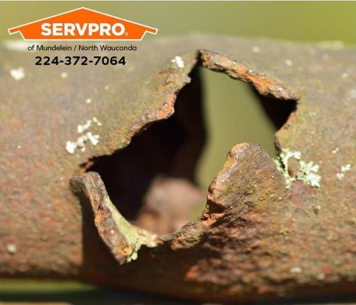 A closeup of a corroded pipe is shown.